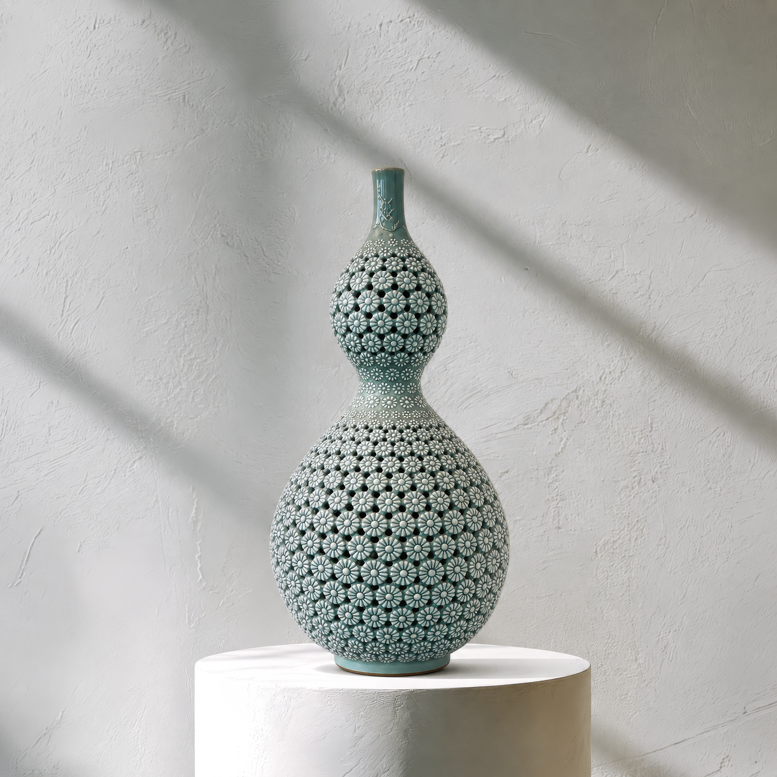 Decorative ceramic vase with textured surface on a white pedestal against a light gray wall.